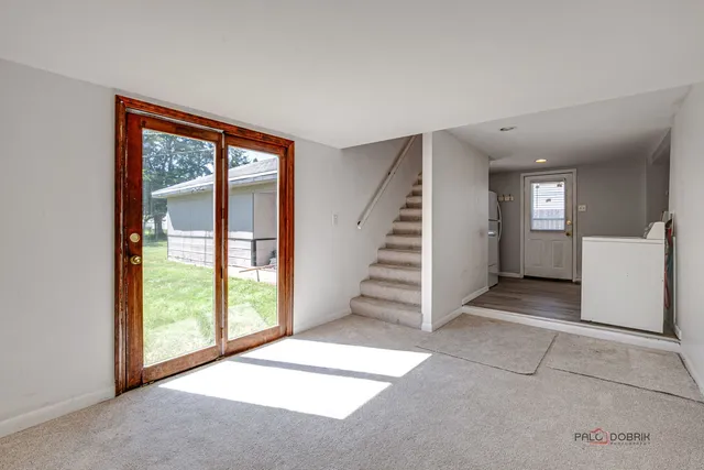 a view of a big room with windows and entryway
