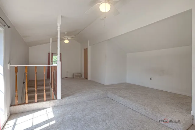 an empty room with windows and pillars in it