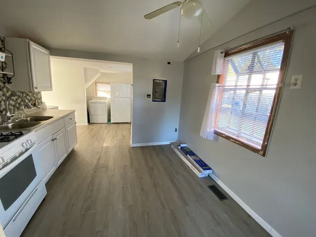 a view of a room with window and wooden floor