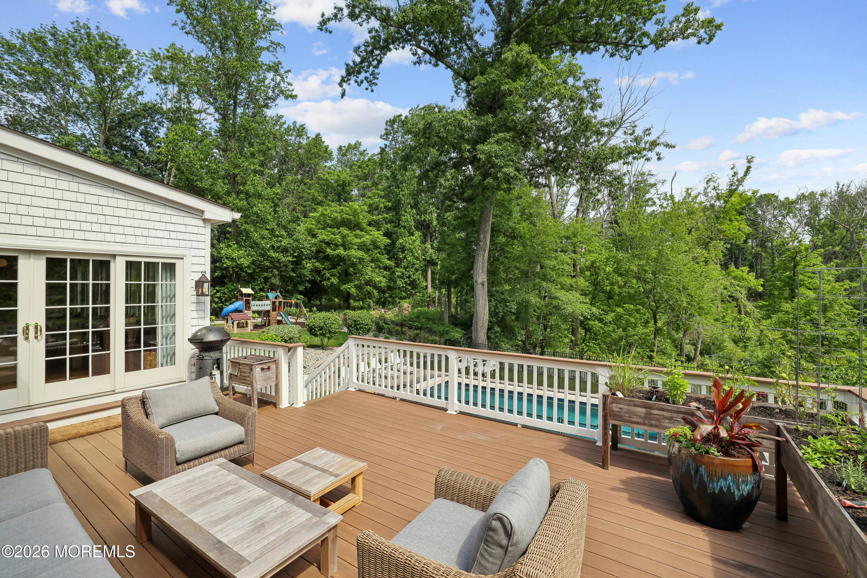 92 Tulip Lane Colts Neck, NJ 07722 - Photo 16 of 55 a view of a deck with a table and chairs