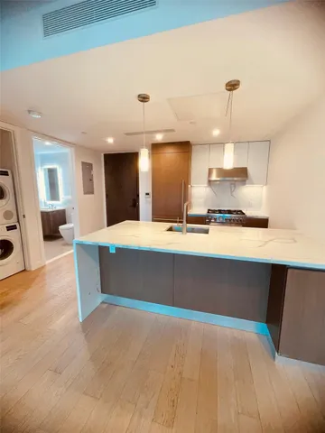 a kitchen with kitchen island a sink and wooden floor