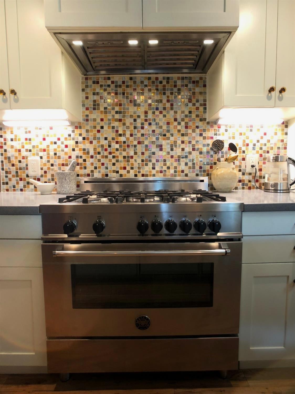 126 Center Street Jackson, CA 95642 - Photo 28 of 79 a stove top oven sitting inside of a kitchen