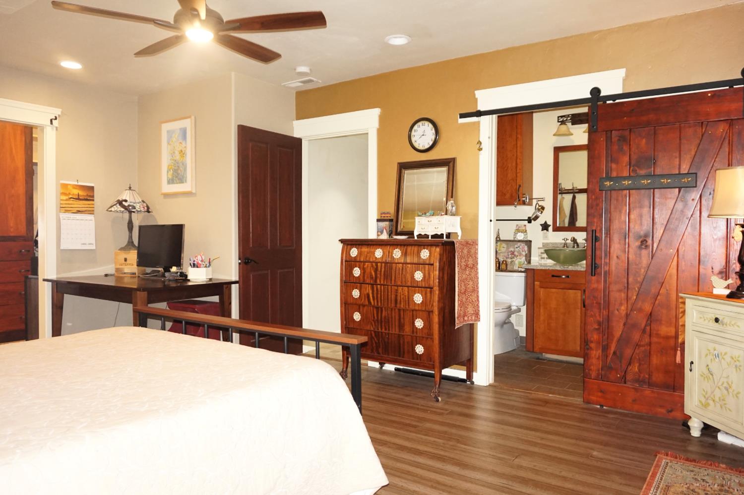 126 Center Street Jackson, CA 95642 - Photo 33 of 79 a bedroom with a bed and wooden floor