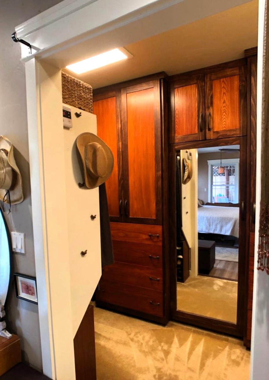 126 Center Street Jackson, CA 95642 - Photo 39 of 79 Primary bedroom walk in closet with multiple hanging, built in cabinets, drawers and mirrored door