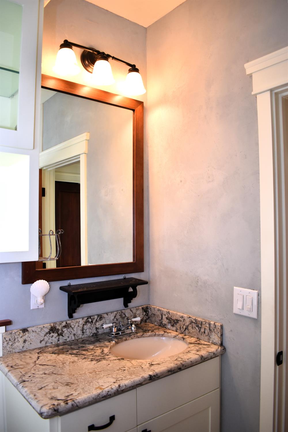 126 Center Street Jackson, CA 95642 - Photo 45 of 79 a bathroom with a granite countertop sink and a mirror