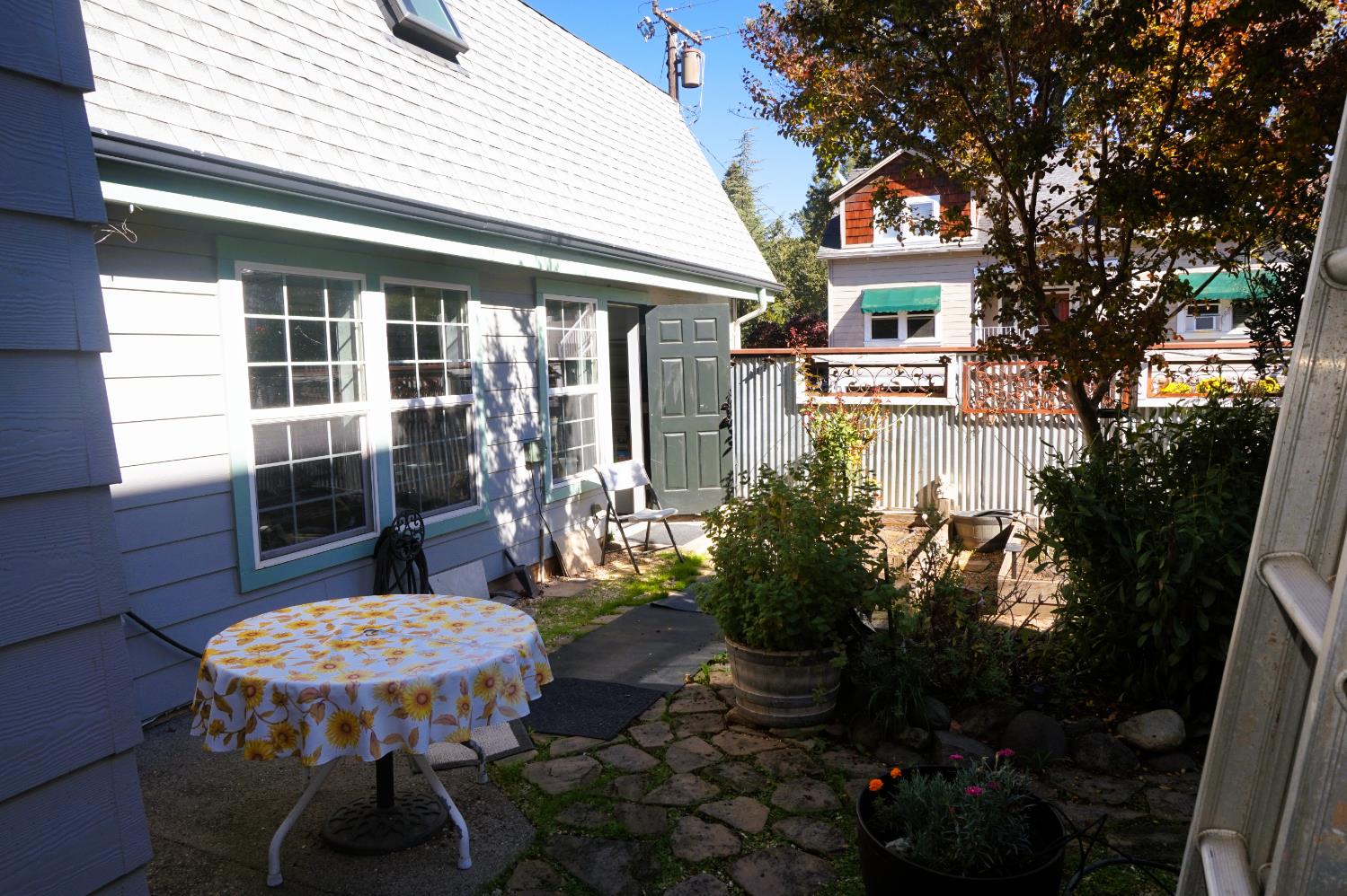 126 Center Street Jackson, CA 95642 - Photo 72 of 79 a view of a patio with table and chairs potted plants and floor to ceiling window