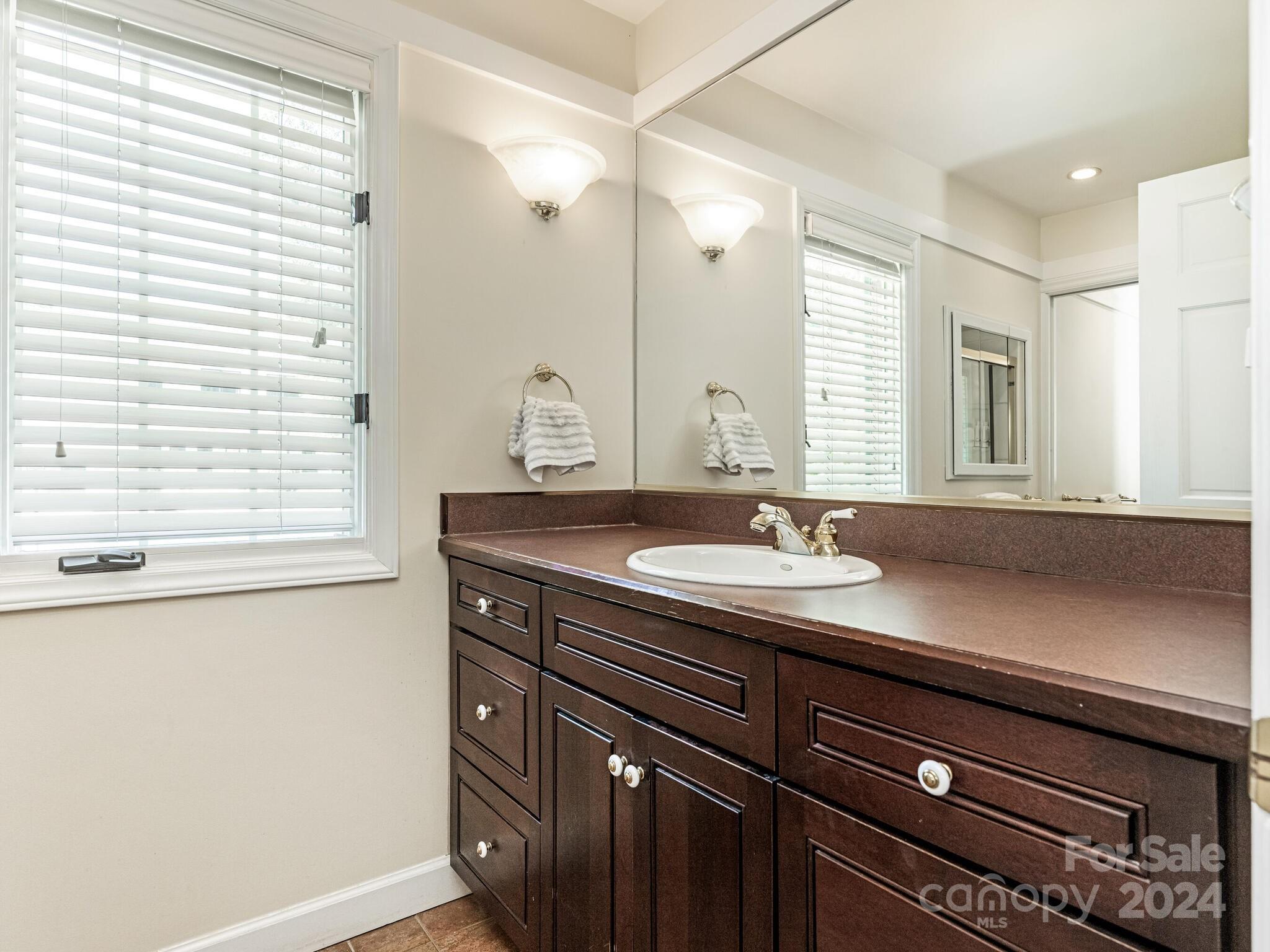 435 Lansdowne Road Charlotte, NC 28270 - Photo 15 of 29 a bathroom with a granite countertop sink and a mirror