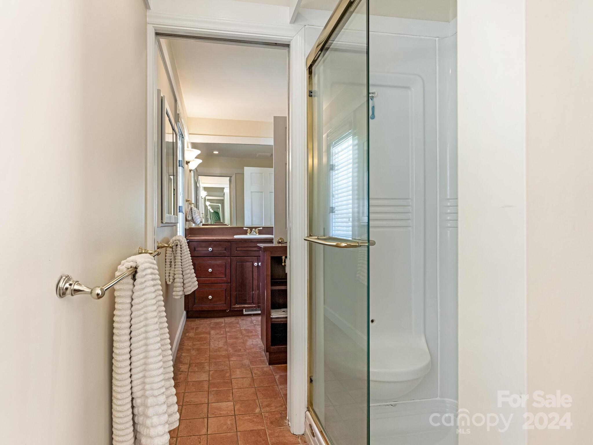 435 Lansdowne Road Charlotte, NC 28270 - Photo 16 of 29 a bathroom with a glass shower door