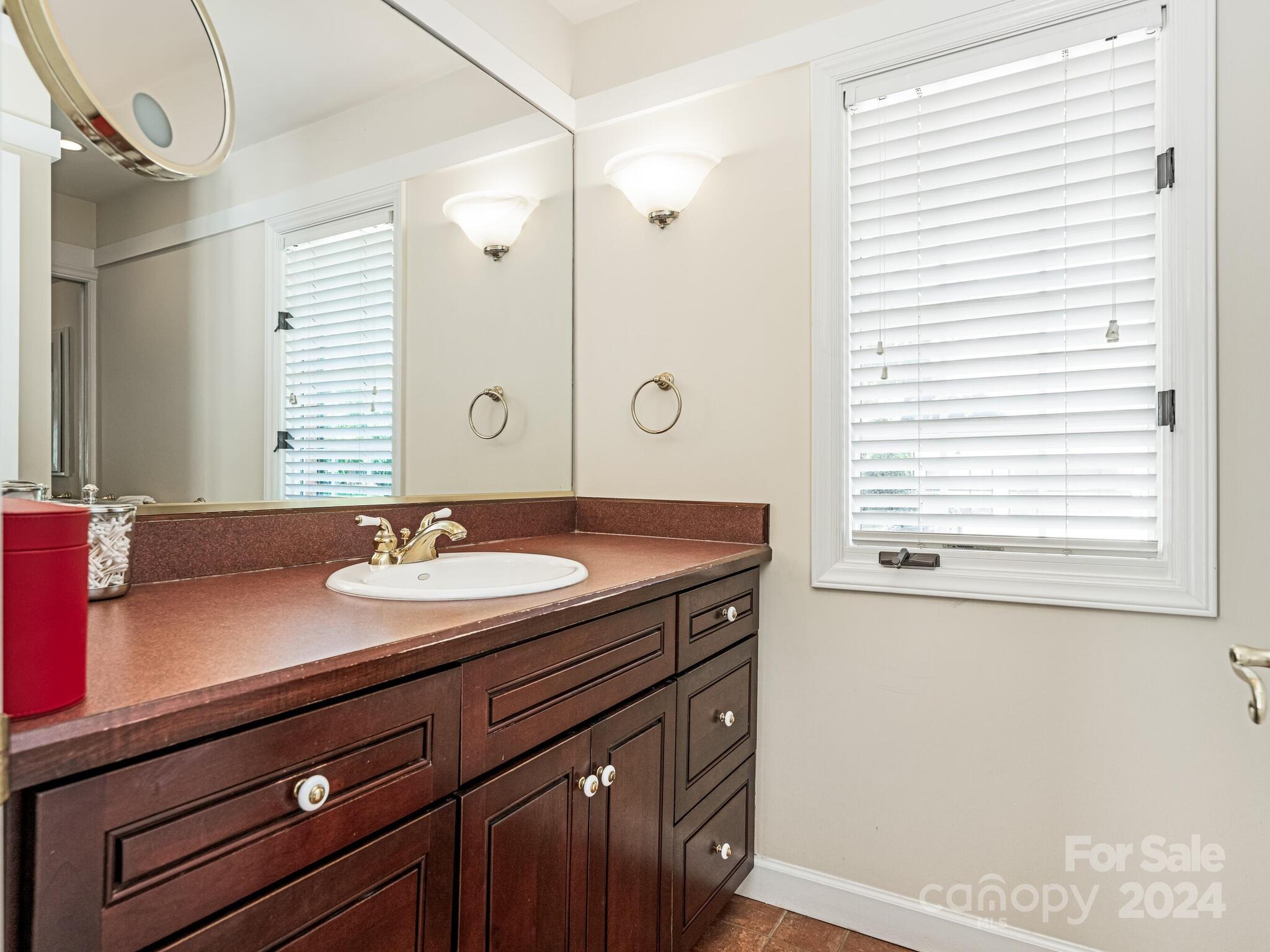 435 Lansdowne Road Charlotte, NC 28270 - Photo 17 of 29 a bathroom with a sink and a mirror