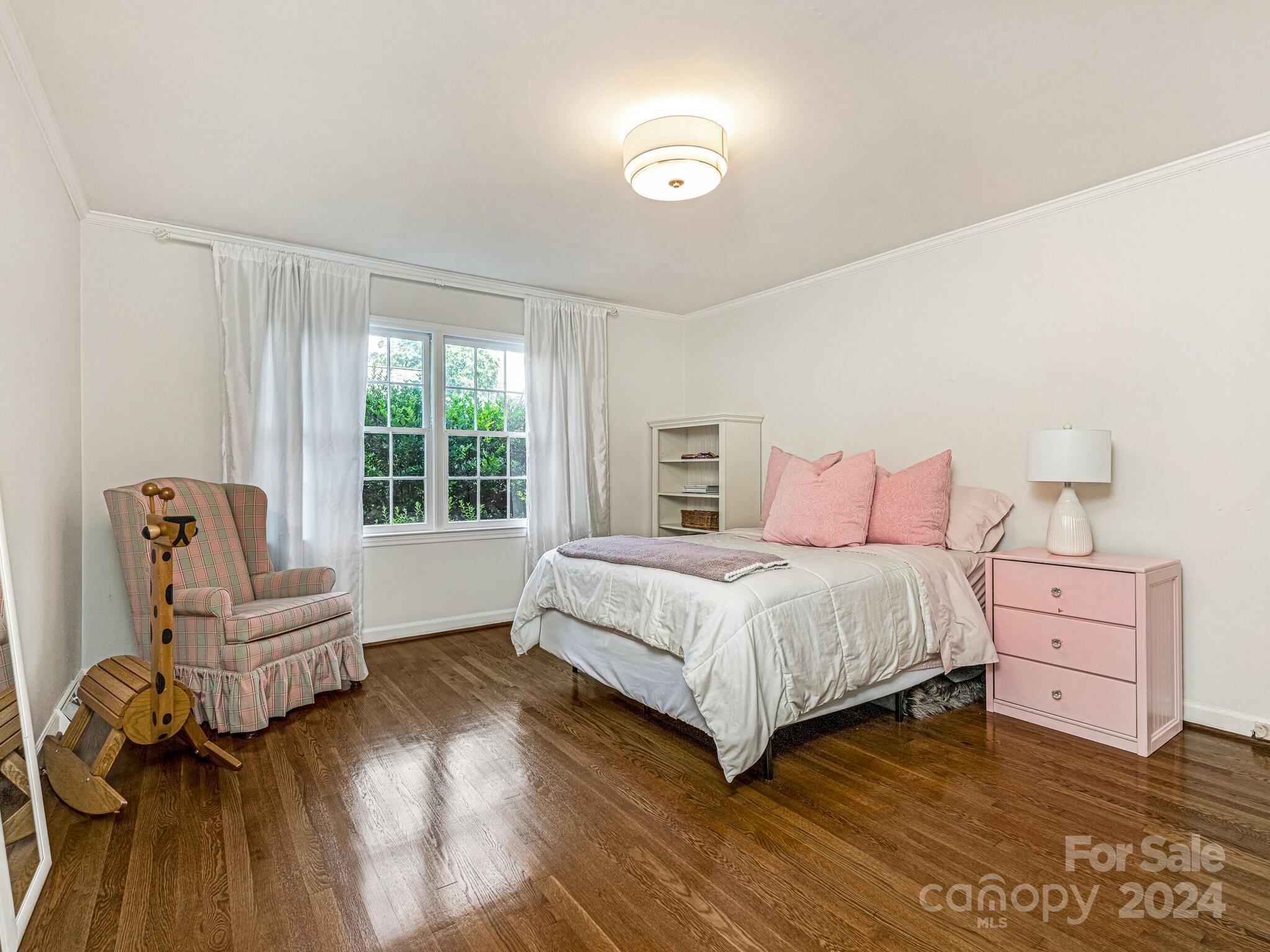435 Lansdowne Road Charlotte, NC 28270 - Photo 18 of 29 a bedroom with a bed and a chair