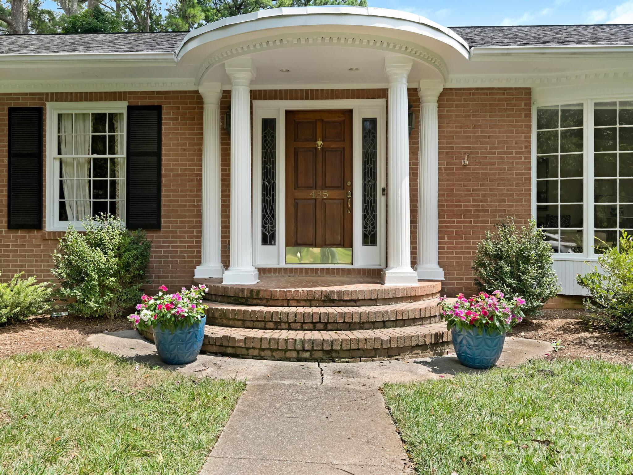 435 Lansdowne Road Charlotte, NC 28270 - Photo 2 of 29 a view of a house with potted plants