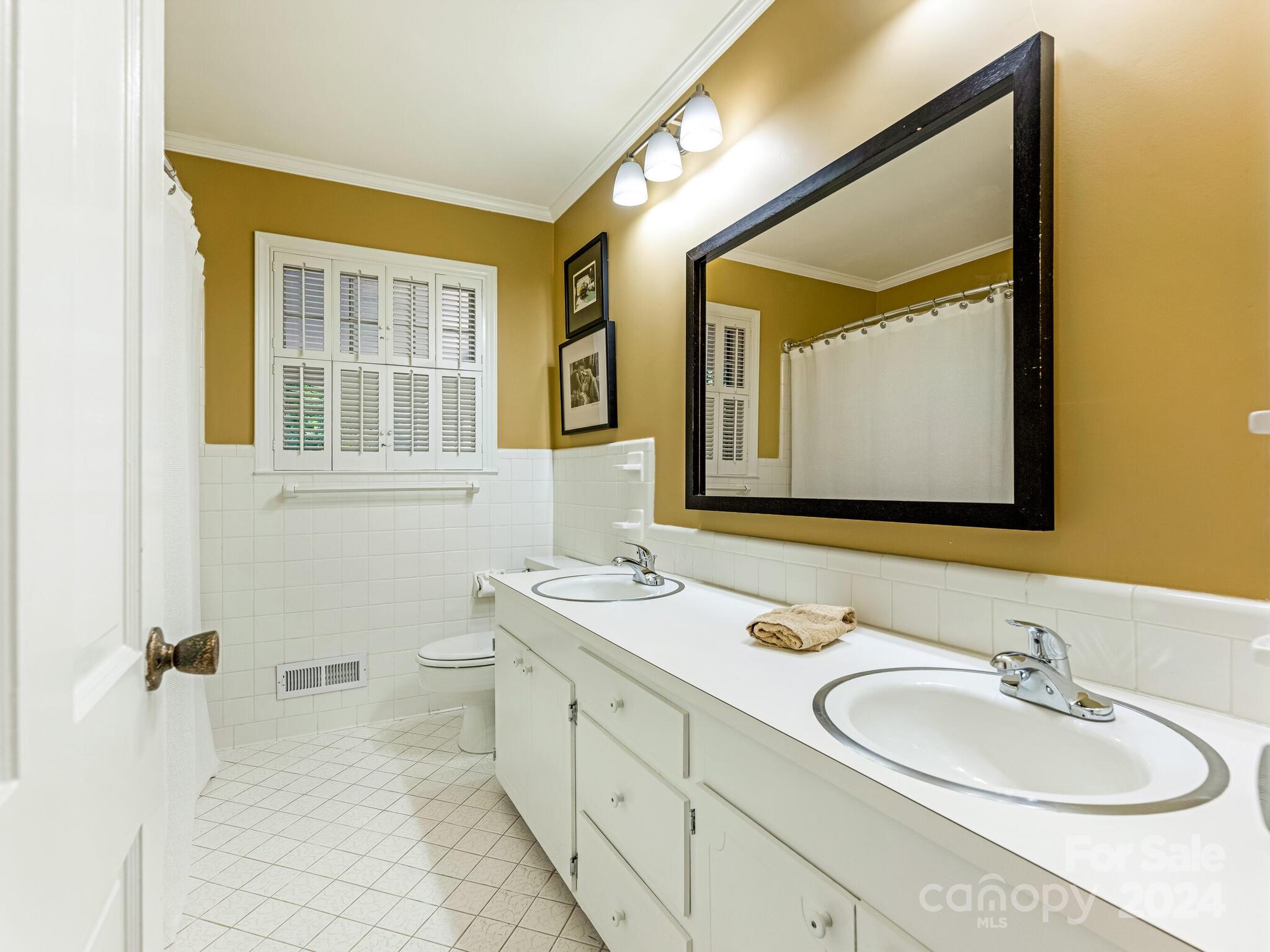 435 Lansdowne Road Charlotte, NC 28270 - Photo 21 of 29 a bathroom with a double vanity sink mirror and double