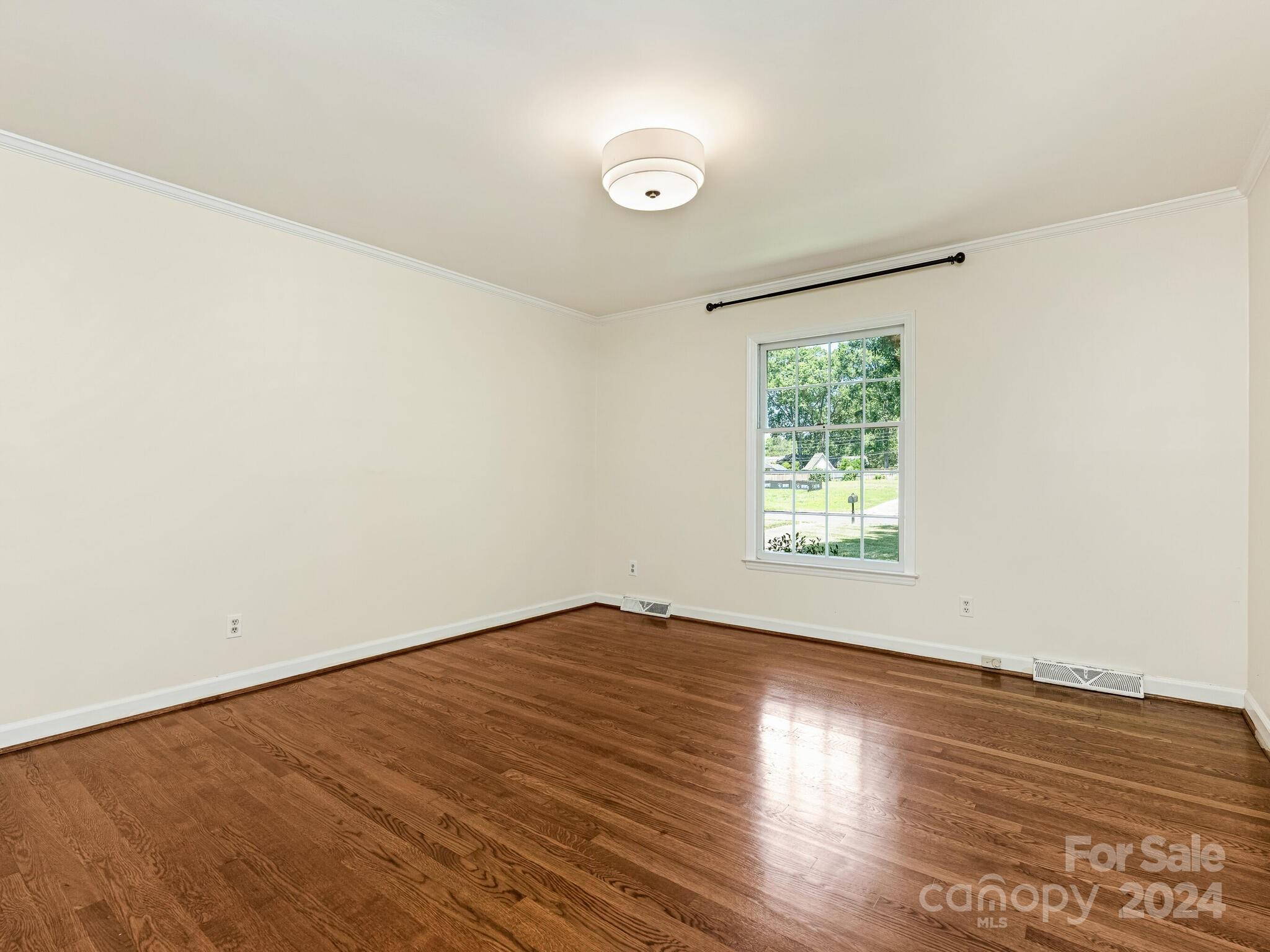 435 Lansdowne Road Charlotte, NC 28270 - Photo 22 of 29 an empty room with wooden floor and windows