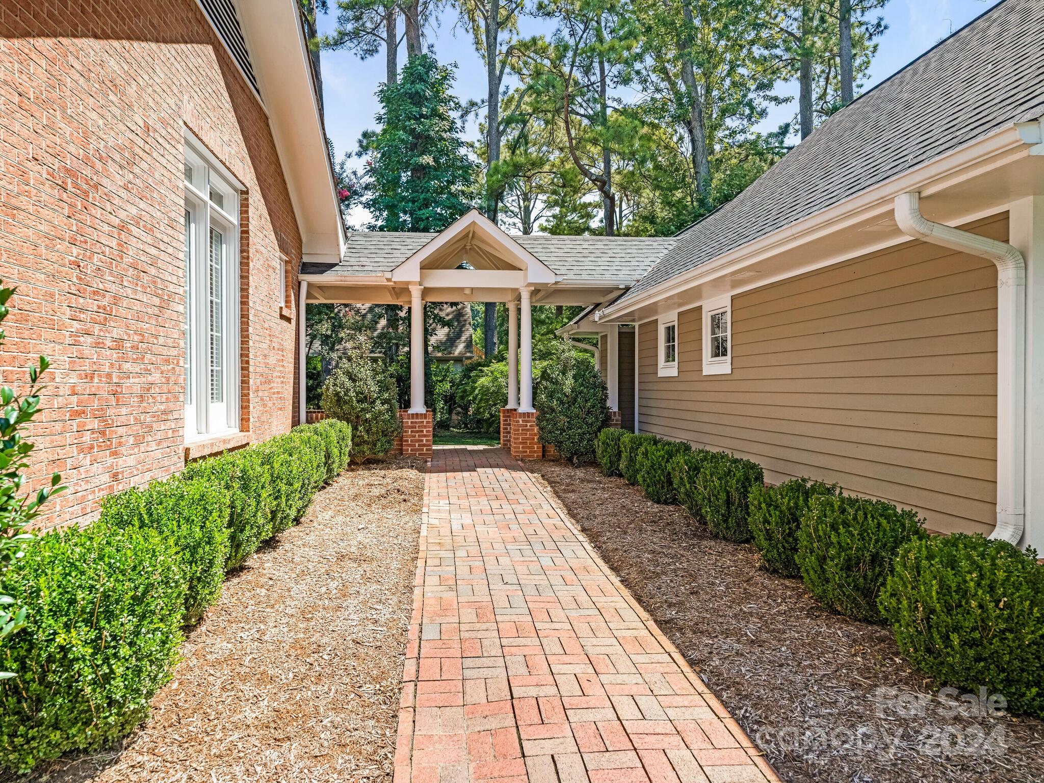 435 Lansdowne Road Charlotte, NC 28270 - Photo 25 of 29 a view of a patio with table and chairs under an umbrella