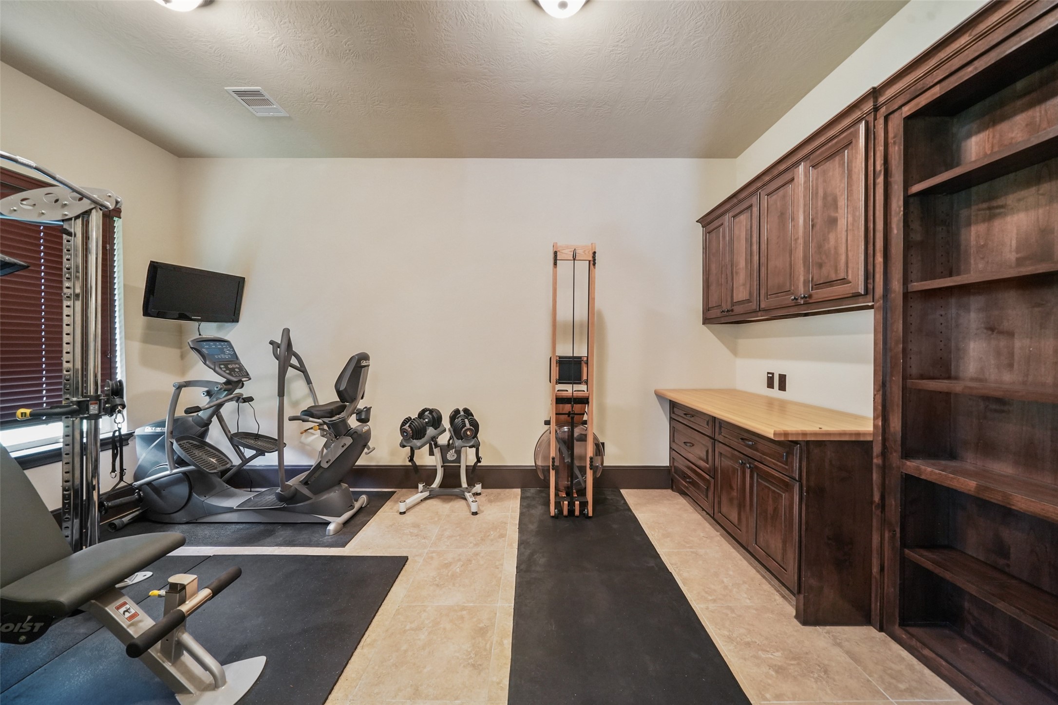 26250 A Riley Road Waller, TX 77484 - Photo 22 of 50 Fitness room with built-in cabinetry and shelving; ample floor space for workouts and storage.