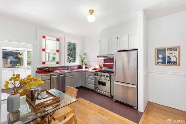 a kitchen with refrigerator and cabinets