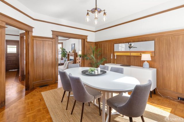 a kitchen with a wooden table and cabinets