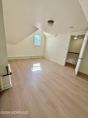a view of an empty room and wooden floor