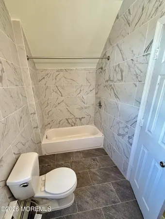 a bathroom with a toilet and a bathtub