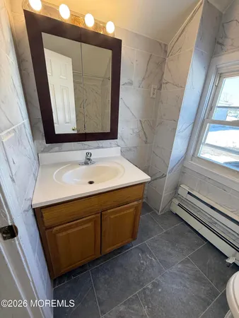 a bathroom with a sink a mirror and a vanity