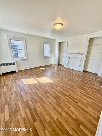 a view of a livingroom with wooden floor and a window