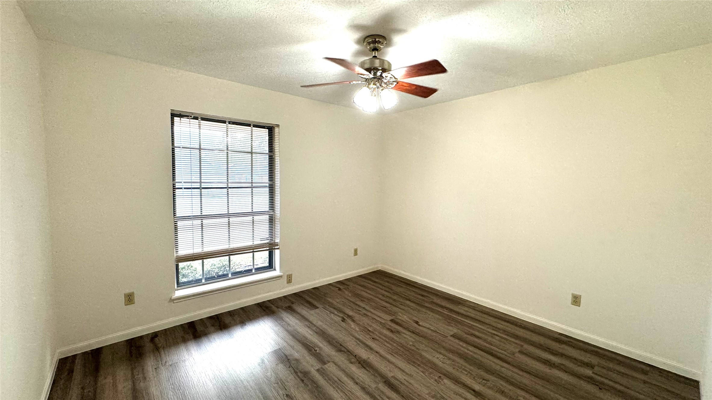 618 Cannon Ball Drive Spring, TX 77380 - Photo 22 of 26 an empty room with wooden floor fan and windows