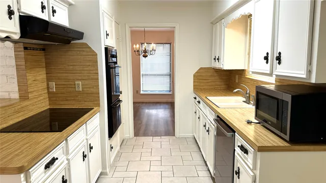 a kitchen with granite countertop a stove and a sink