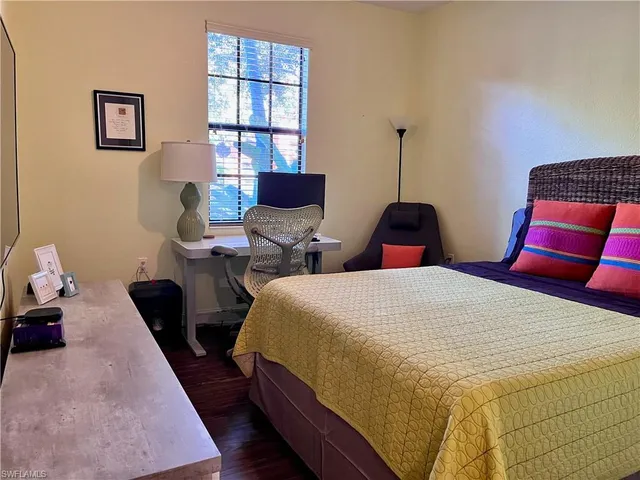 a bedroom with bed and window