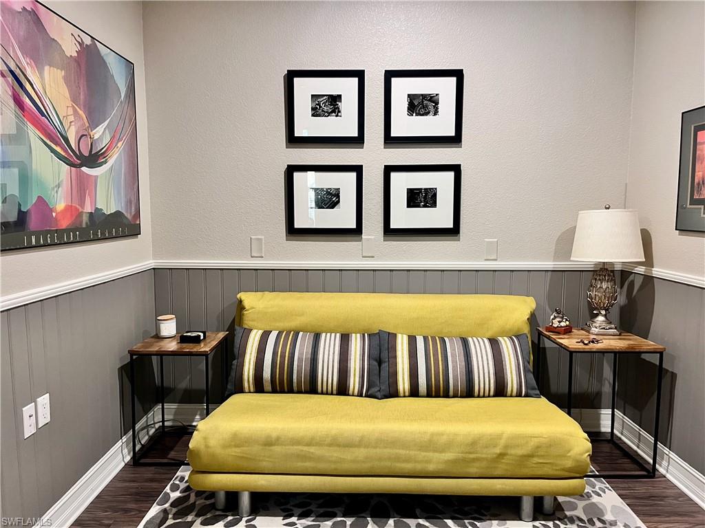 9126 Chula Vista Street, Unit 12301 Naples, FL 34113 - Photo 12 of 36 a bedroom with a bed and paintings on the wall