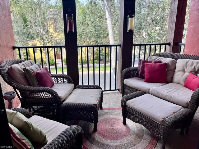 a balcony with furniture and a large window