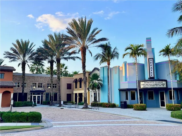 a view of multiple houses with palm trees