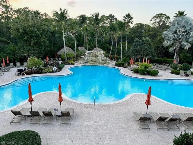 a swimming pool with outdoor seating and yard