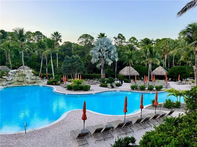 a view of swimming pool with outdoor seating and plants
