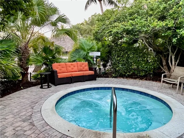 a swimming pool with outdoor seating