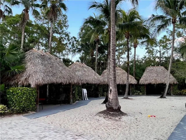 a front view of a house with yard and trees