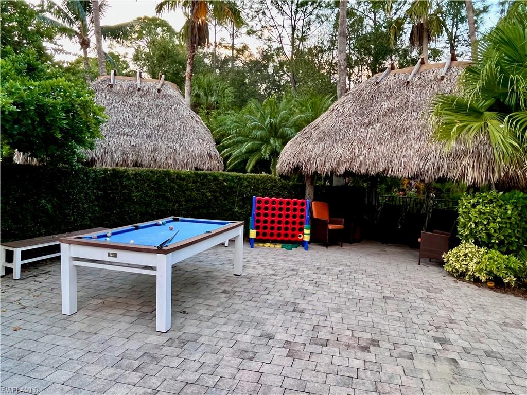 9126 Chula Vista Street, Unit 12301 Naples, FL 34113 - Photo 28 of 36 a backyard of a house with lots of green space