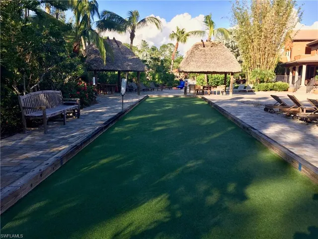 a front view of a house with a garden and sitting area