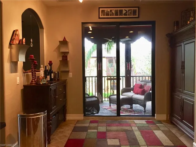 a view of living room with a floor to ceiling window and kitchen