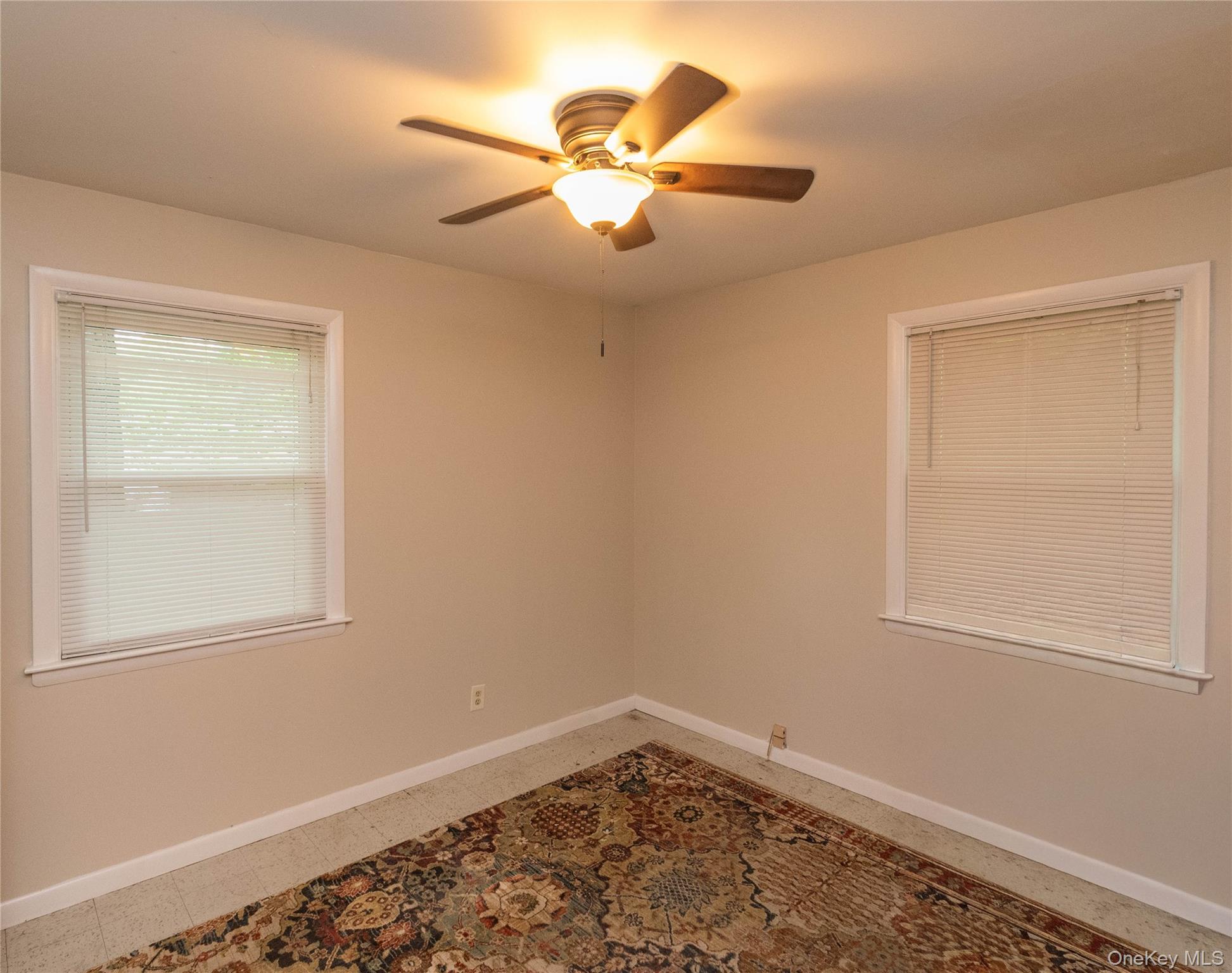 543 Dosen Road Middletown, NY 10940 - Photo 14 of 25 Neutral wall tones with white trim, two windows, and a ceiling fan