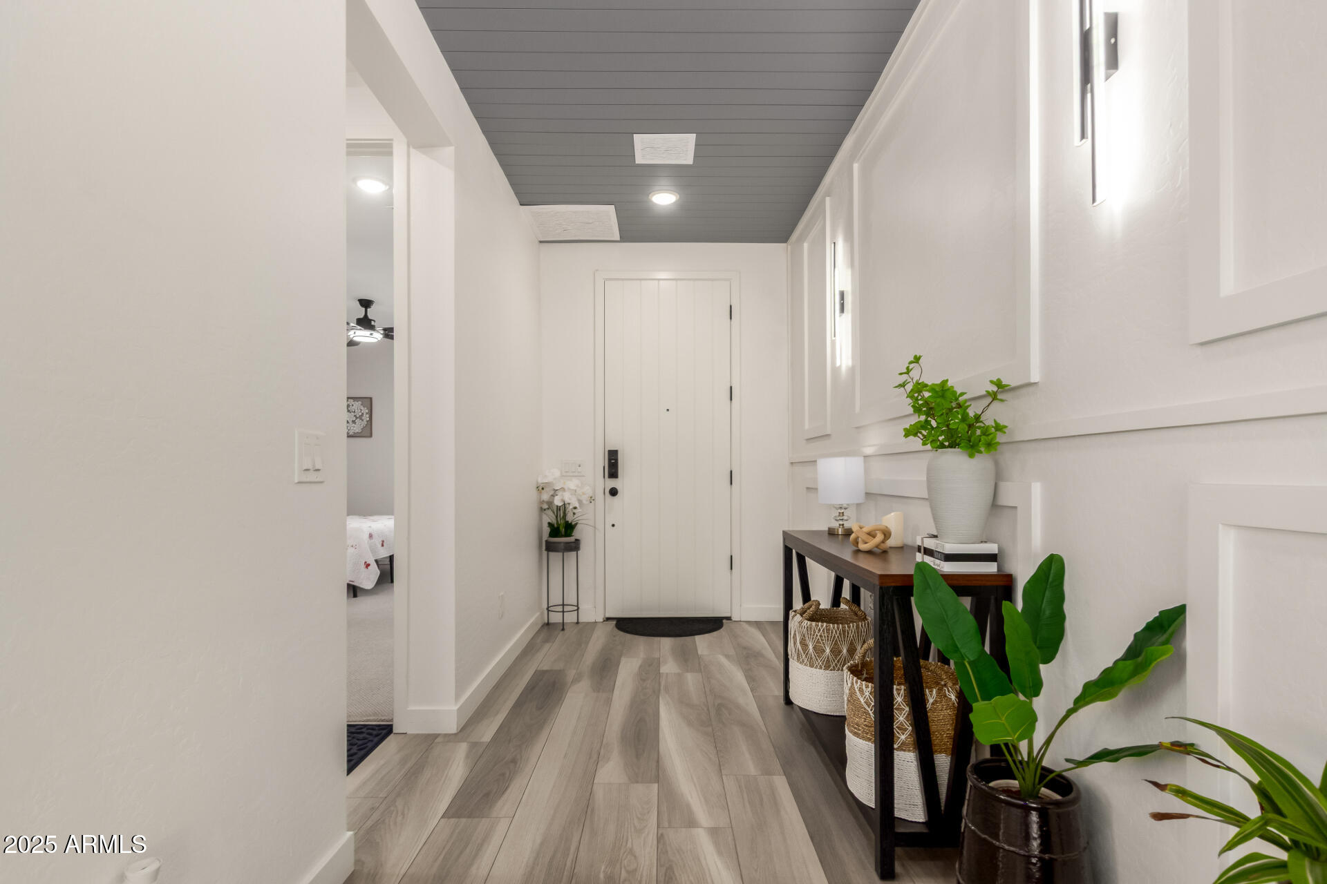 1501 East Rakestraw Lane Gilbert, AZ 85298 - Photo 9 of 71 a view of a hallway with wooden floor and a potted plant