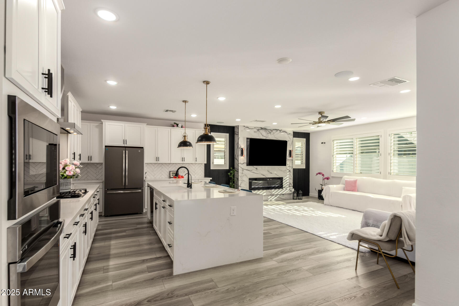 1501 East Rakestraw Lane Gilbert, AZ 85298 - Photo 19 of 71 a living room with stainless steel appliances furniture and a flat screen tv