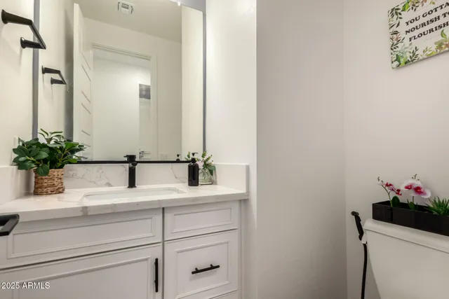 a bedroom with a bed and a ceiling fan