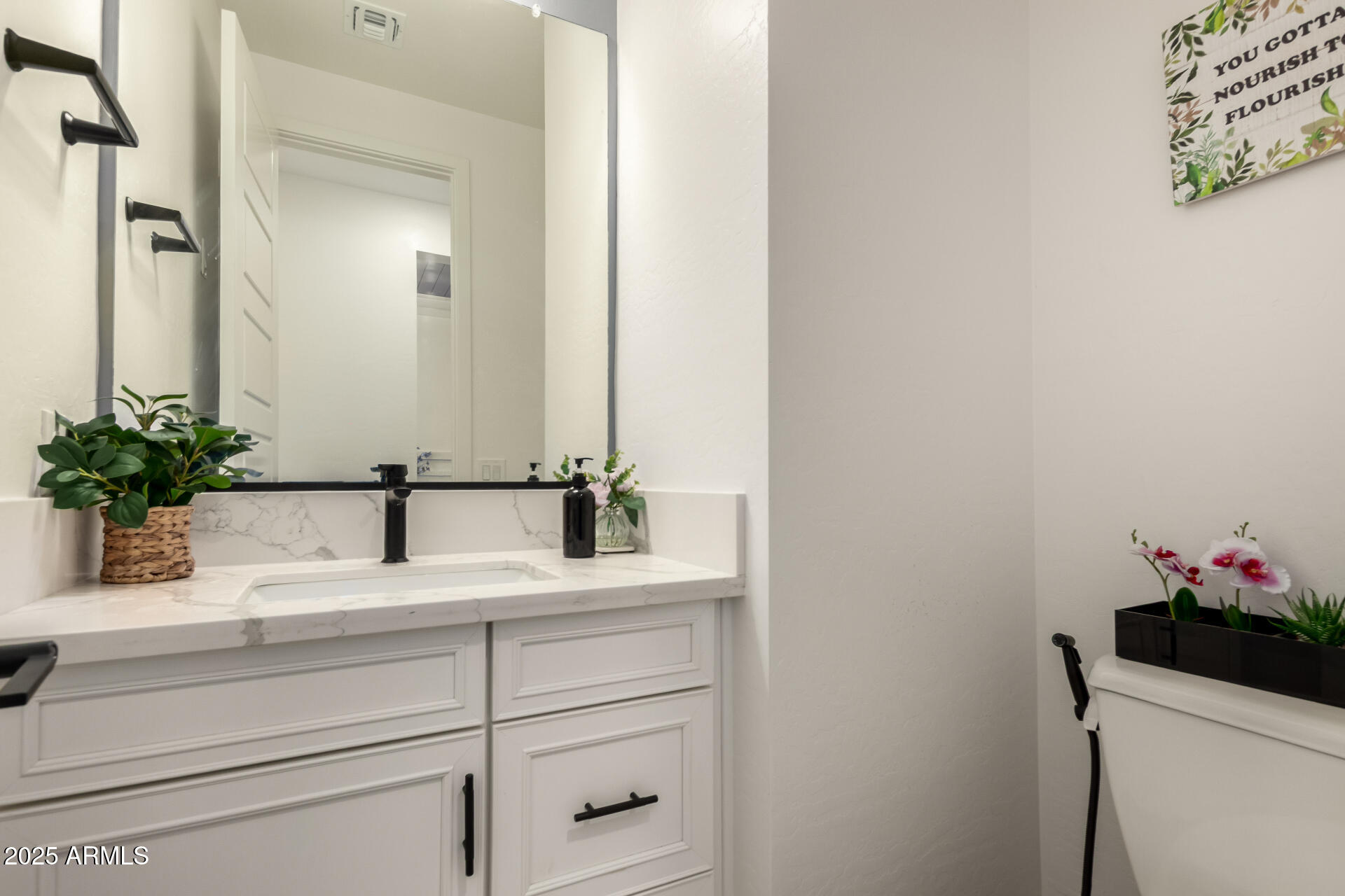 1501 East Rakestraw Lane Gilbert, AZ 85298 - Photo 24 of 71 a bathroom with a sink and a mirror