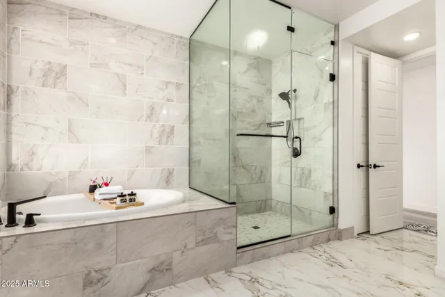 a bathroom with a granite countertop sink a toilet and a large mirror