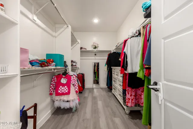 a view of staircase with lots of frames on wall and a window