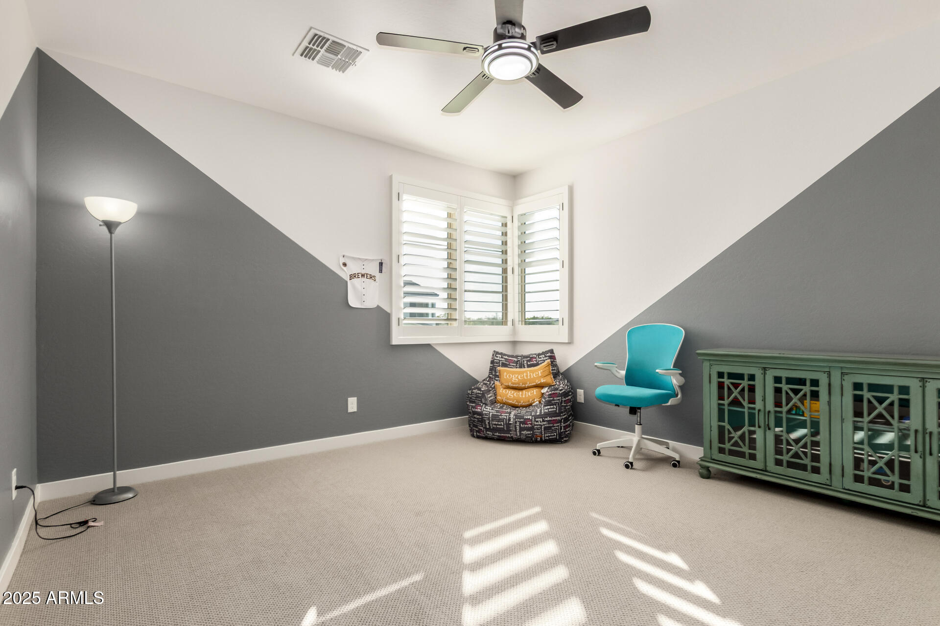 1501 East Rakestraw Lane Gilbert, AZ 85298 - Photo 37 of 71 a living room with furniture a window and gym equipment