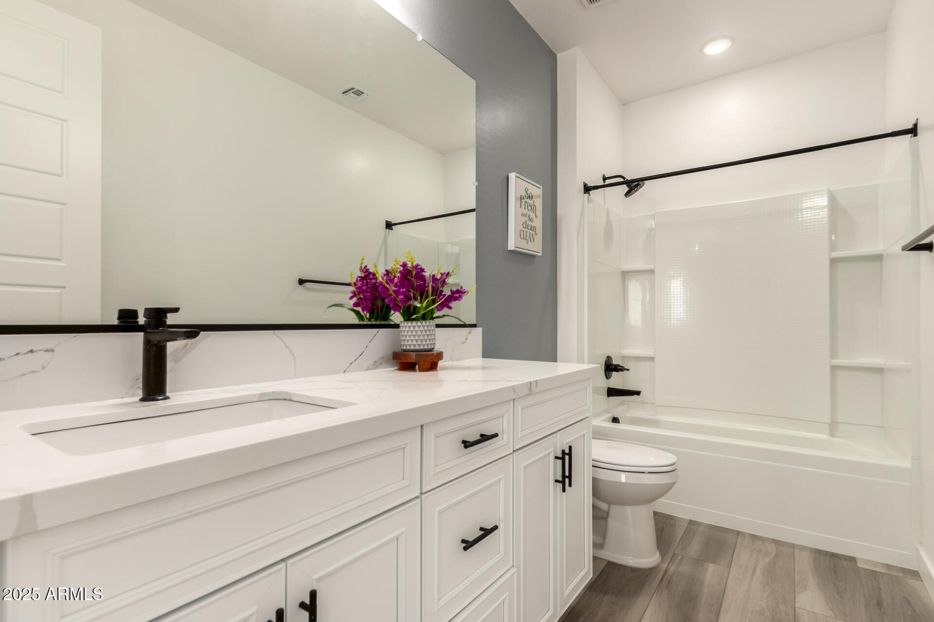 1501 East Rakestraw Lane Gilbert, AZ 85298 - Photo 41 of 71 a bathroom with a granite countertop sink a toilet and a large mirror