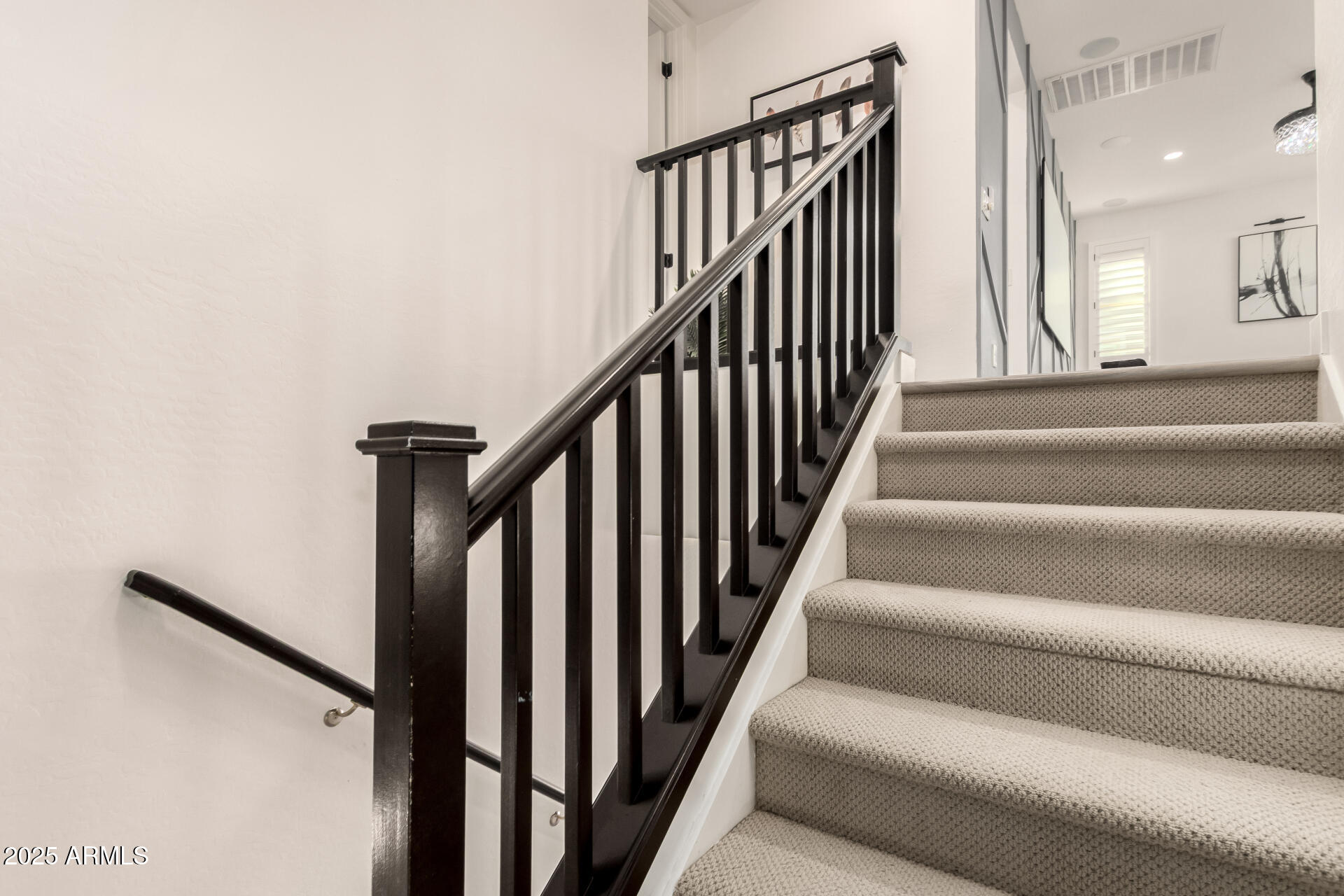 1501 East Rakestraw Lane Gilbert, AZ 85298 - Photo 42 of 71 a view of staircase with lots of frames on wall and a window
