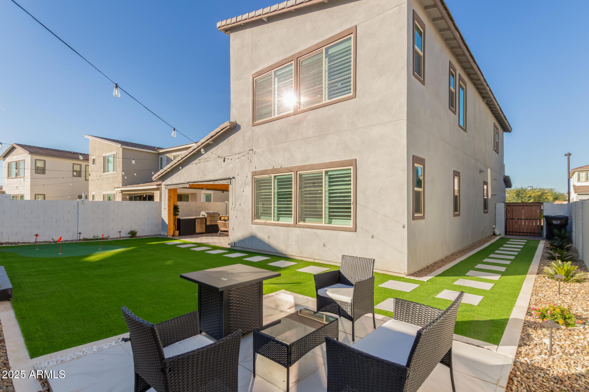 1501 East Rakestraw Lane Gilbert, AZ 85298 - Photo 54 of 71 a view of a house with backyard sitting area and furniture