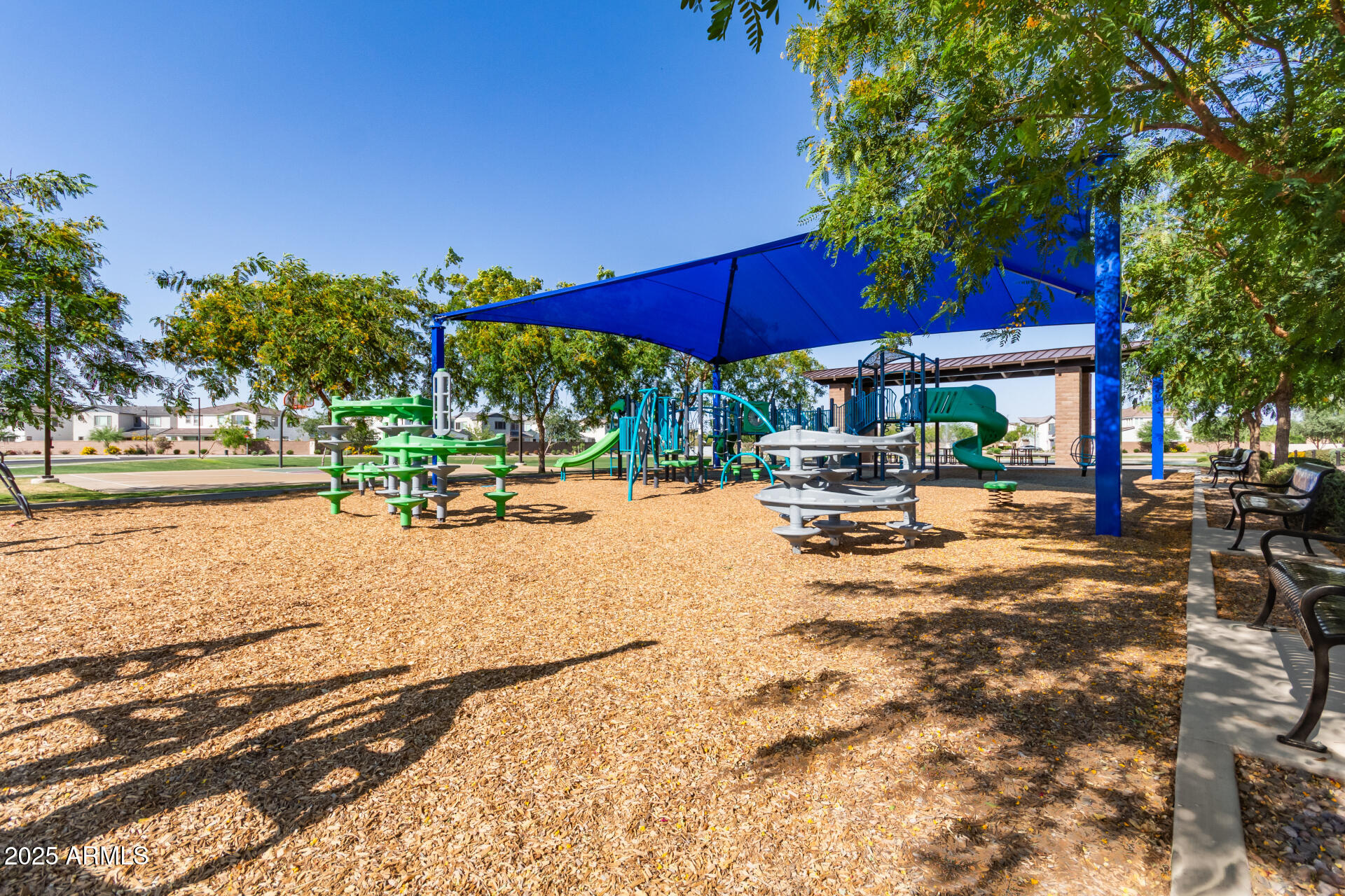 1501 East Rakestraw Lane Gilbert, AZ 85298 - Photo 56 of 71 a view of the patio with a table and chairs under an umbrella